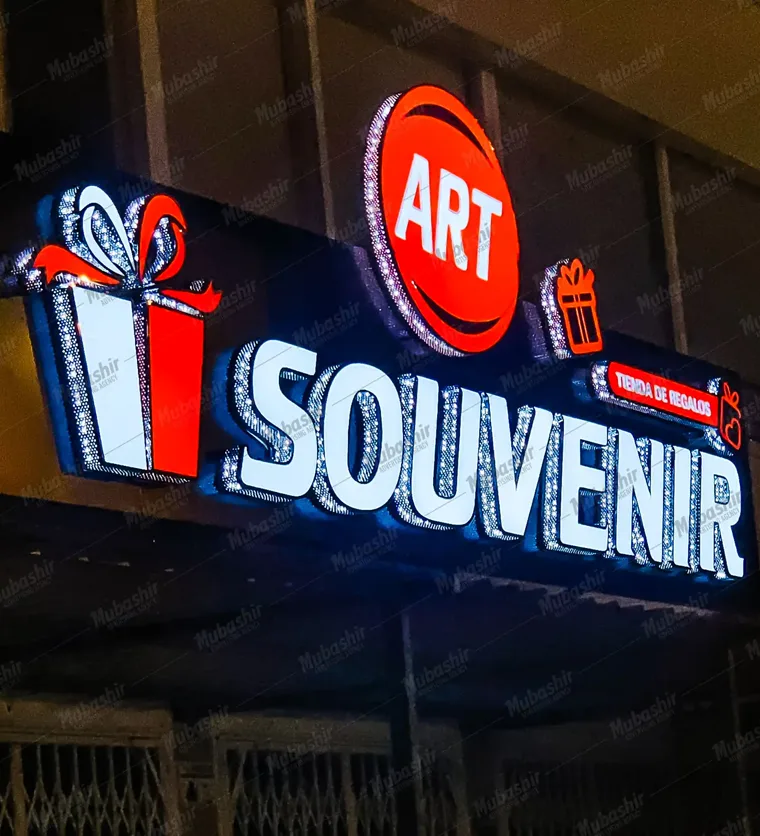 ART Souvenir illuminated storefront sign installed at night