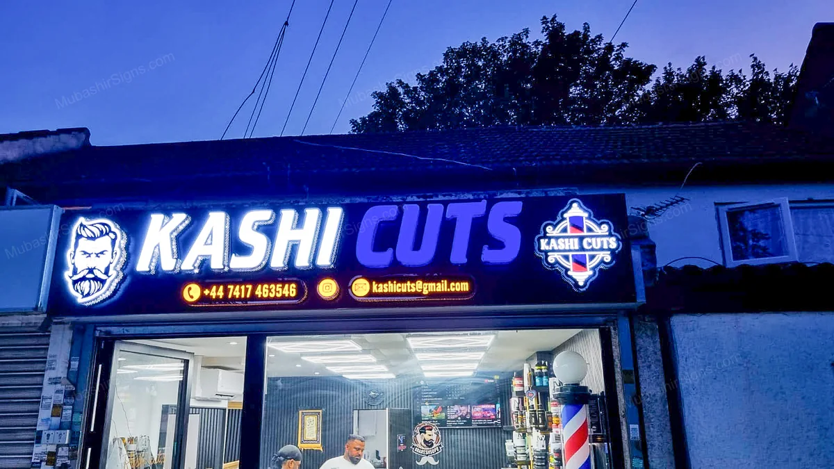 Client-supplied installed view — the illuminated sign above the Kashi Cuts entrance in Hounslow.